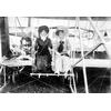 Mrs. Frank Coffyn (left) and an unidentified woman posing in an early Wright Model B at an air meet.