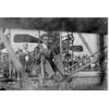 Frank Coffyn at the controls of a Wright transitional aircraft. The blurred man in background resembles Ralph Johnstone.