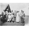 Frank Coffyn, his wife, and military personnel posing in front of a tent, Fort Sam Houston, Texas.