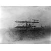 Orville Wright taking off in a Wright transitional aircraft.