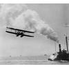 Frank Coffyn flying near a tugboat, New York Harbor.