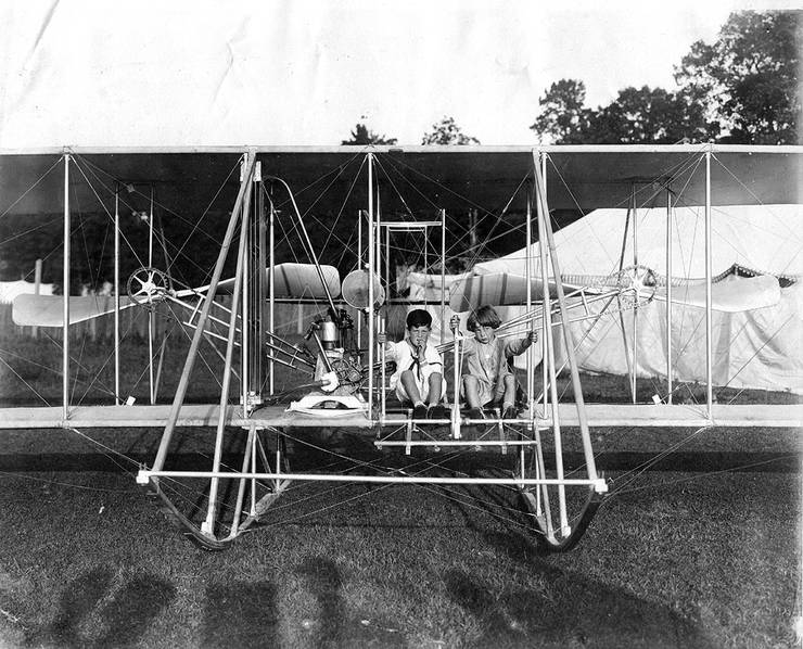Kingsland Coffyn (right) and an unknown child posing in a Wright aircraft.