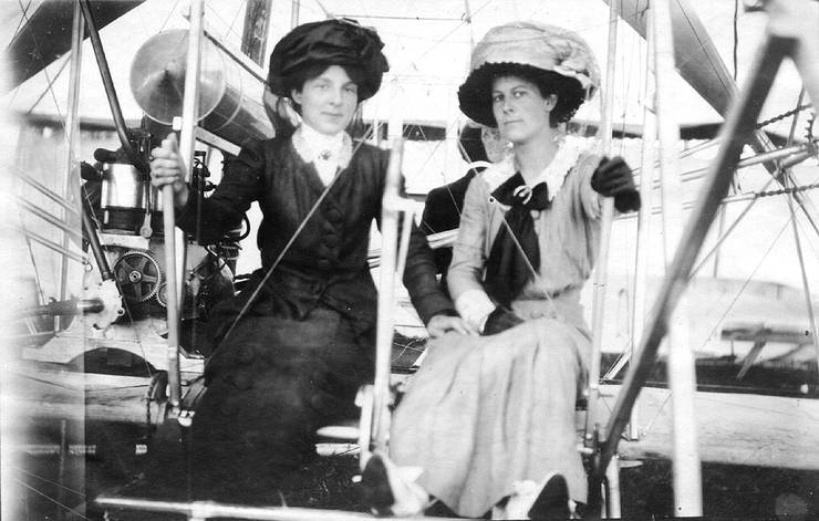 Mrs. Frank Coffyn (left) and an unidentified woman posing in an early Wright Model B at an air meet.