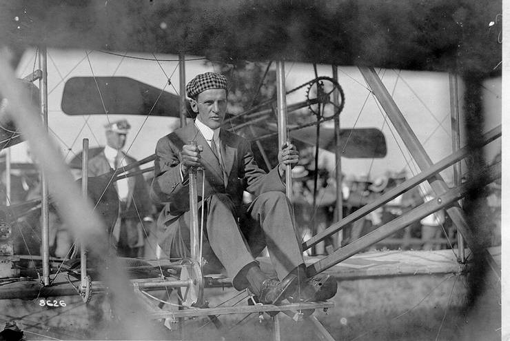 Frank Coffyn at the controls of a Wright transitional aircraft. The blurred man in background resembles Ralph Johnstone.