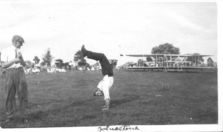 Frank Coffyn watching Ralph Johnstone doing a handstand.