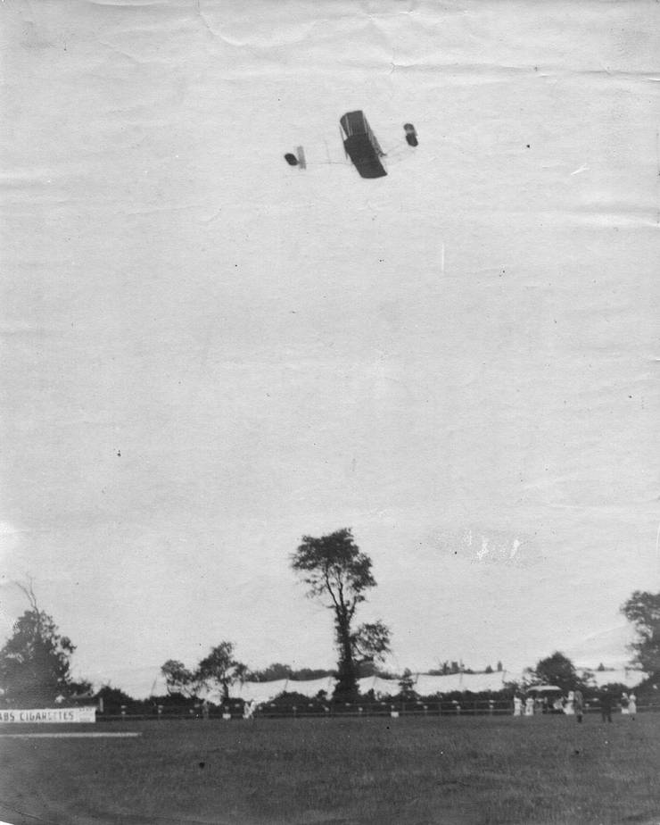 Wright transitional in flight over an air meet.
