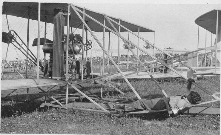 Frank Coffyn resting on the skid of a Wright transitional during an exhibition.