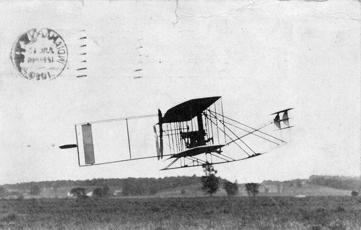 Postcard depicting a Wright transitional aircraft in flight.