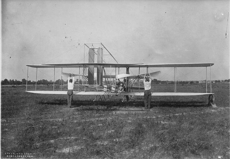 Spencer Crane, Walter Brookins and Arch Hoxsey prepare to start a Wright transitional aircraft, Montgomery, Alabama.