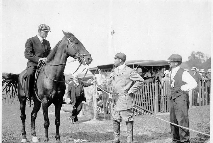 Frank Coffyn on horseback, speaking to Ralph Johnstone and Duval La Chapelle.