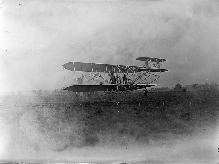 Orville Wright taking off in a Wright transitional aircraft.