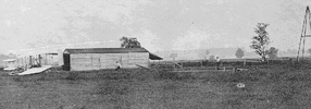 The 1904 Flyer 2 catapulted into the air. The derrick and weight are at the extreme right of the photo.